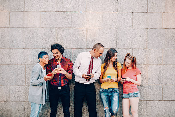 five people at different ages texting and sharing with each other.